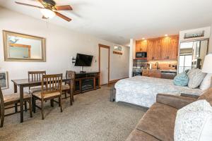 a bedroom with a bed and a table and a kitchen at 243 Bldg C condo in Truckee