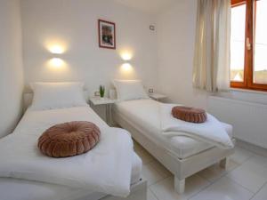 two beds in a room with white walls and a window at Villa Gabriel - Three Bedroom Villa with Outdoor Pool in Drniš +33 photos