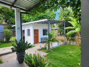 Una pequeña casa blanca con un patio con plantas. en Casa frente al lago, en Sacramento 11 fotos más