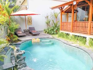 a swimming pool in the backyard of a house at Anggi Villas Ubud in Tegalalang