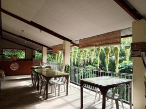 a patio with tables and chairs on a balcony at Casa-de Aplaya in Gasan