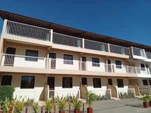 an exterior view of a building with white balconies at Casa-de Aplaya in Gasan