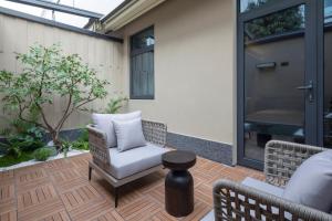 a patio with chairs and a table and a door at Atour Hotel Suzhou Gusu Dongzhong in Suzhou