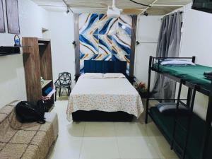a bedroom with a bed and two bunk beds at Loft-Expo Norte-Brás-Anhembi in São Paulo