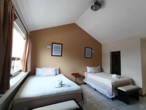a bedroom with two beds and a window at Hotel Casa Blanca Inn in Estación Pamplona