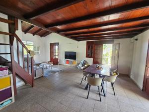 a living room with a dining room table and chairs at Zen'Nature&Chill House - Punta Cana Room in Petit-Canal