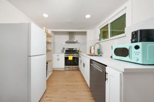 a kitchen with white cabinets and a blue microwave at remodeled 2b 1b house Rosemead c in Rosemead