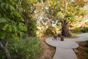 a walkway with a table and chairs in a park at remodeled 2b 1b house Rosemead c in Rosemead