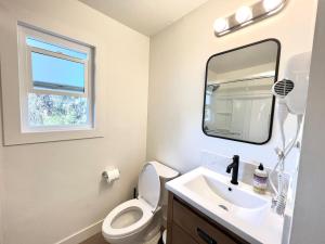 a bathroom with a sink and a toilet and a mirror at remodeled 2b 1b house Rosemead c in Rosemead +17 photos