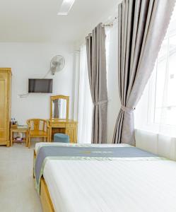 a bedroom with a bed and a window at Ngân Hà Xanh Hotel in Da Lat