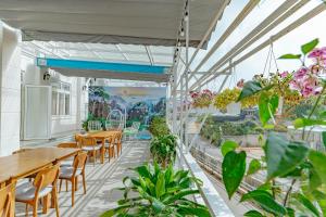 a restaurant with tables and chairs and plants at Ngân Hà Xanh Hotel in Da Lat