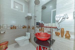 a bathroom with a sink and a toilet and a mirror at Ngân Hà Xanh Hotel in Da Lat +27 photos
