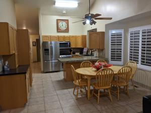 a kitchen with a table and chairs and a refrigerator at Beautiful Large Residential Home in Layton