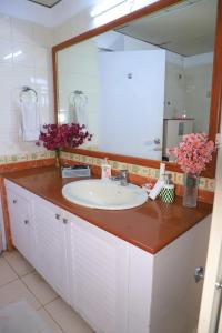 a bathroom with a sink and a large mirror at Fortune Home,MG Road,Essel Tower in Gurgaon