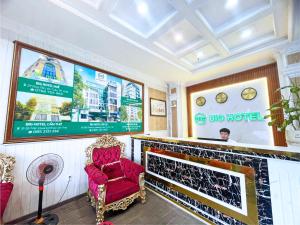 a bar with a red chair in a room at BIG Central Hotel Can Tho - 7 Minutes to Ninh Kieu Wharf in Can Tho