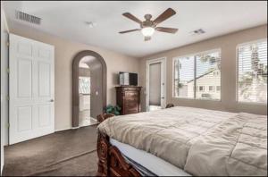 a bedroom with a bed and a ceiling fan at The Reserve Large Home and Pool in Phoenix +31 photos
