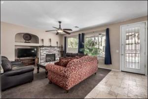 a living room with a couch and a chair at The Reserve Large Home and Pool in Phoenix