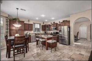 a kitchen with a table and chairs and a dining room at The Reserve Large Home and Pool in Phoenix