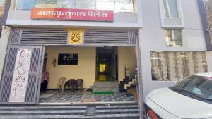 a white car parked in front of a building at Hotel Mahamrityunjay Palace in Ujjain +4 photos