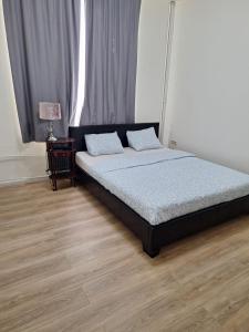a bed with two pillows on it in a bedroom at Maison sympathique in Liège +15 photos
