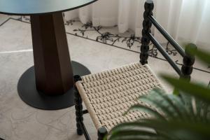 a rattan chair sitting next to a table at Town Designer B&B in Qingdao
