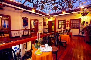 a room with tables and chairs and a ceiling at Hotel Cantuña in Quito