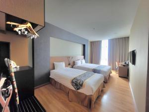 Postel nebo postele na pokoji v ubytování Roxy Hotel & Apartments