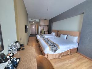 Postel nebo postele na pokoji v ubytování Roxy Hotel & Apartments