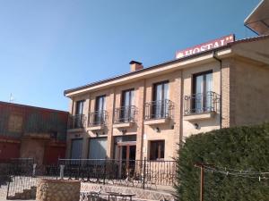 a building with a sign on top of it at Domus Viatoris in Sahagún