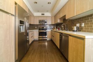 a large kitchen with wooden floors and stainless steel appliances at Western Santa Monica in Los Angeles