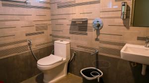 a bathroom with a toilet and a sink at Kodai Elliott in Kodaikānāl +43 photos
