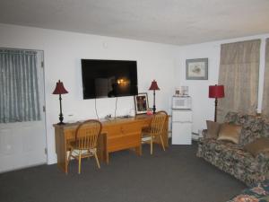a living room with a desk and a couch at Bonanza Gold Motel in Dawson City