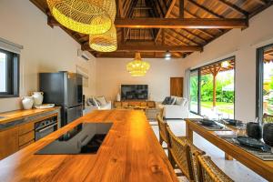 eine Küche mit einem großen Holztisch und Stühlen in der Unterkunft Luxury 2BR Tropical Villa in Jimbaran, Bali in Jimbaran