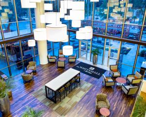 an overhead view of a lobby with chairs and tables and chandeliers at The Whitehall Houston in Houston