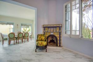 a living room with a fireplace and a chair at Can cruspinera With 6 Bedroom in Tiana