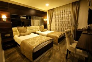 Кровать или кровати в номере Venus Suite Hotel