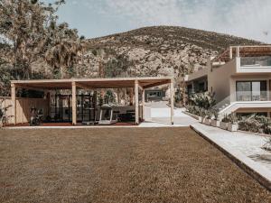 a house with a mountain in the background at Sagredo Boutique Hotel & Spa in Ágios Fokás