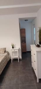 a bedroom with a bed and a table and a dresser at Tsampikas House in Faliraki