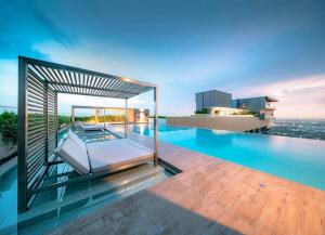 a pool on the roof of a building at River Cando Perfect for relaxing in Ban Sai Ma