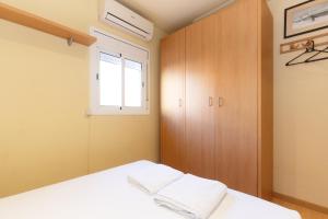 a bedroom with a white bed and a window at Apartment Bed&BCN Sant Andreu II in Barcelona