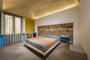 A bed or beds in a room at Hotel Vento del Sud Még 37 kép