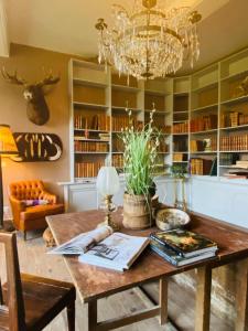 a dining room with a table and a chandelier at Chateau Ciers in Saint-Ciers-sur-Gironde