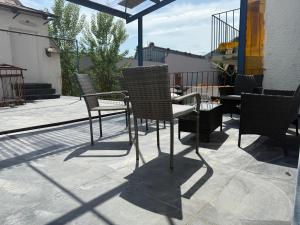 a group of chairs and an umbrella on a patio at GRAZis Apartments in Graz