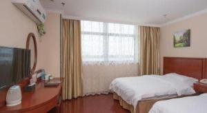 Ένα ή περισσότερα κρεβάτια σε δωμάτιο στο GreenTree Inn Wuhu Fangte Second Phase Nanxiang Wanshang Express Hotel