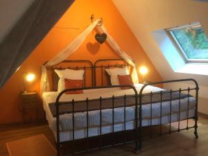 a bedroom with a canopy bed in a attic at Domaine de Joreau in Gennes