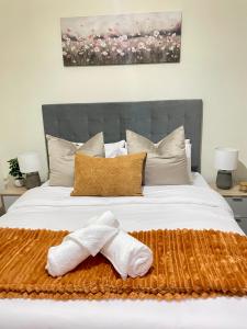 a bedroom with a bed with two towels on it at Luxury 1-Bedroom Apartment in Fourways-Sandton with FREE Gym, swimming Pool and Restaurant in Fourways +26 photos