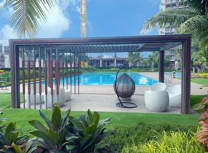 a gazebo with a pool in the background at Skyhouse BSD by Kakarama Room in Cilenggang
