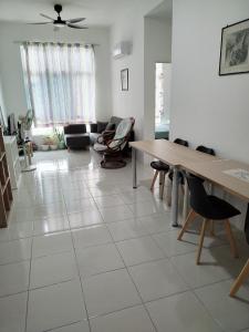 a living room with a table and chairs at Anderson Condo ipoh in Ipoh
