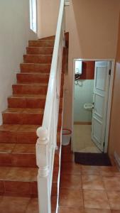 a stairway with a white rail and a door at Villa Kota Bunga Q4-17 in Cikundul