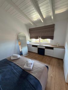 a bedroom with a bed and a mirror and a sink at Vitamine Luxury Apartments 2 in Sarandë